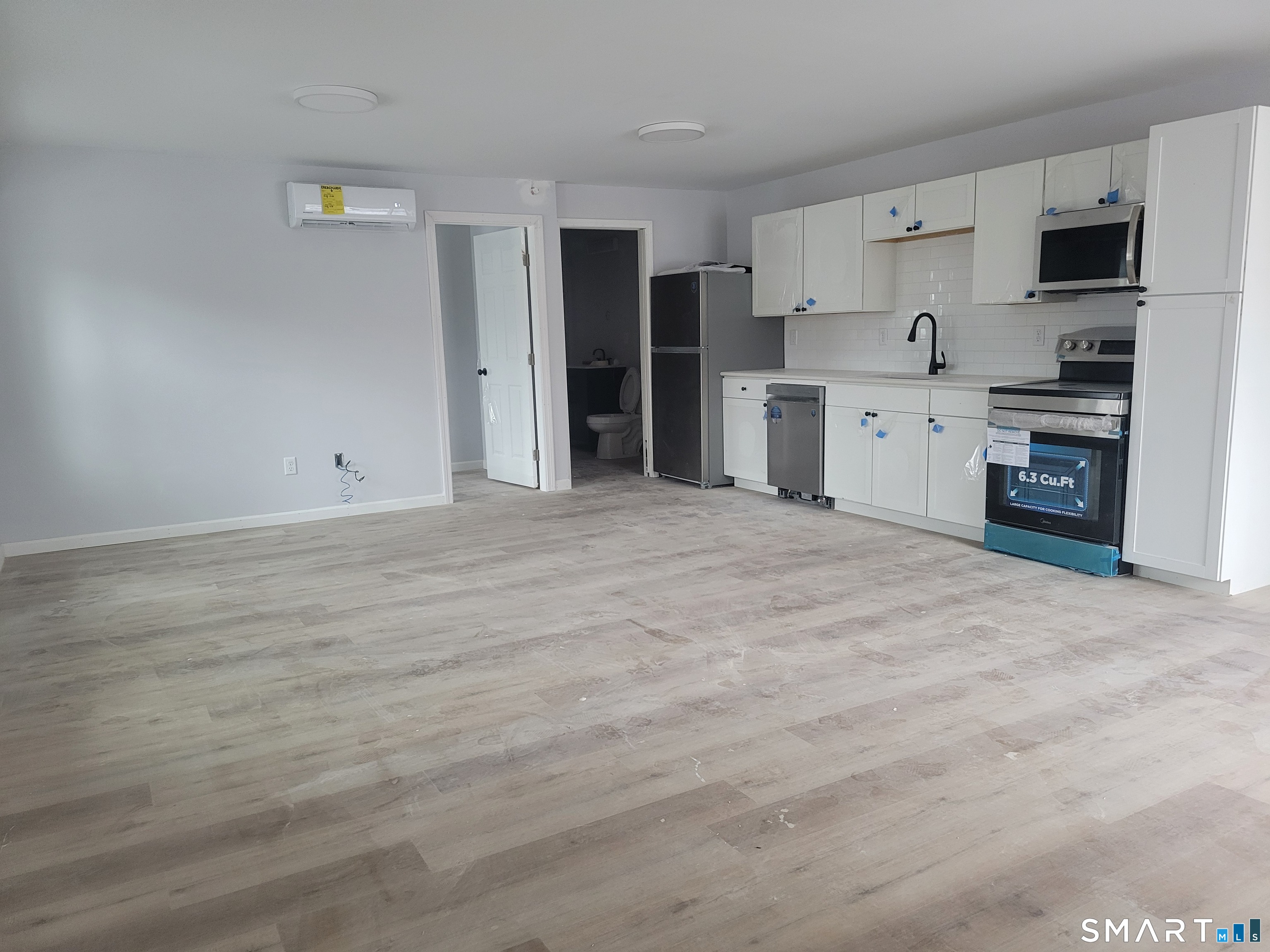 194 Hartford Road, Unit B Manchester, CT 06040 - Photo 5 of 6 a view of a kitchen with a sink and a refrigerator