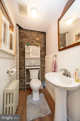 a bathroom with a sink toilet and mirror