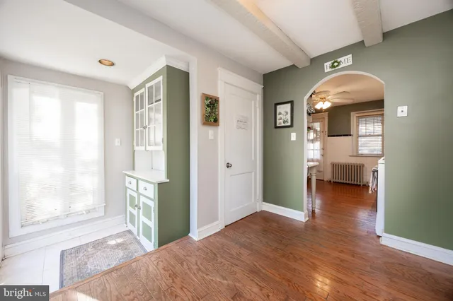 a view of livingroom with natural light and hardwood floor