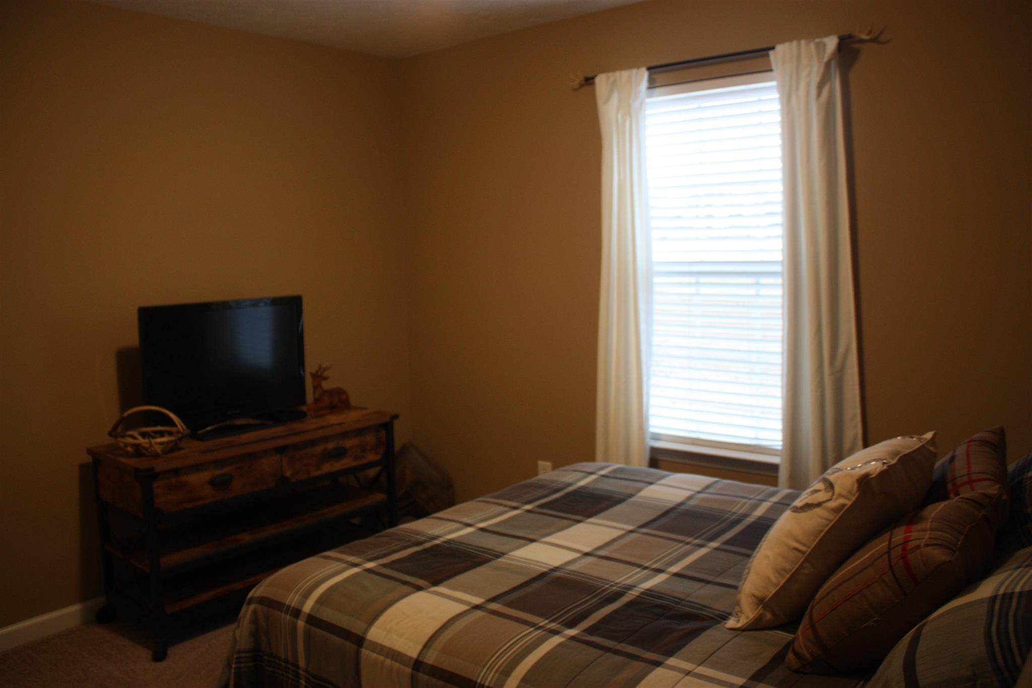 776 Cedar Grove Road Lebanon, TN 37087 - Photo 16 of 24 a bedroom with a bed and a flat screen tv