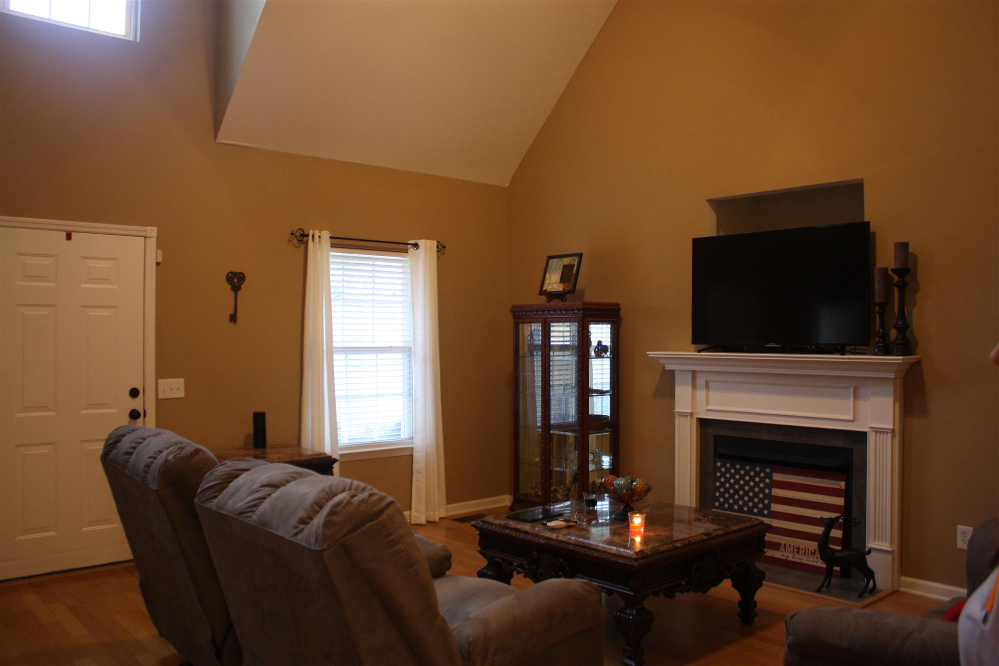 776 Cedar Grove Road Lebanon, TN 37087 - Photo 6 of 24 a living room with furniture a flat screen tv and a fireplace