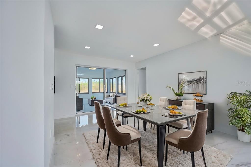 2310 Laguna Drive Indian Lake Estates, FL 33843 - Photo 12 of 27 a view of a dining room with furniture and chandelier