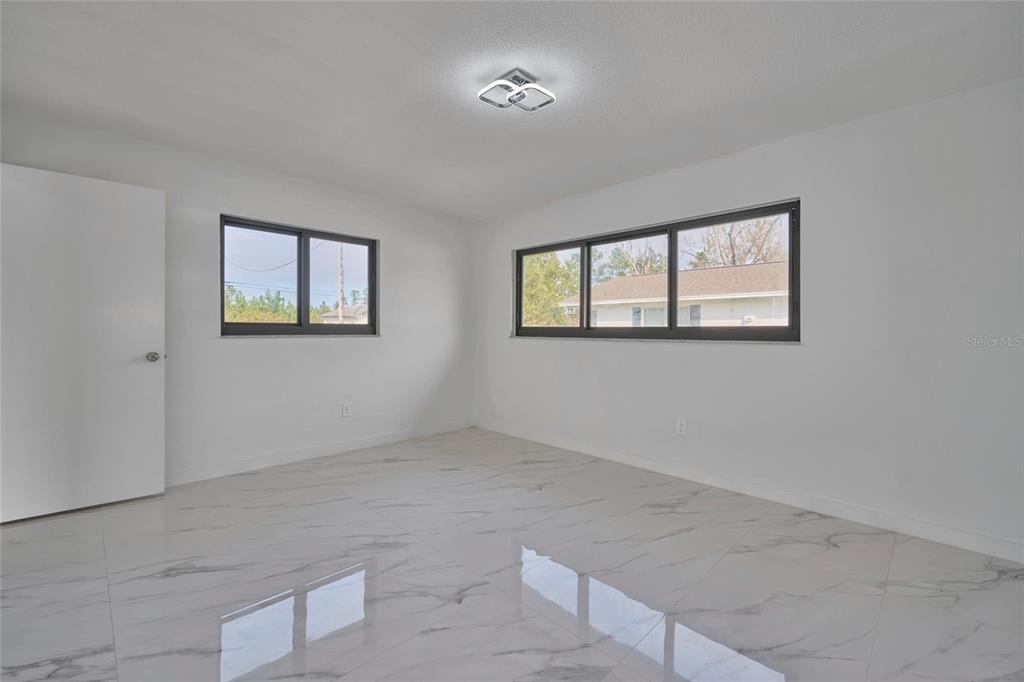 2310 Laguna Drive Indian Lake Estates, FL 33843 - Photo 15 of 27 an empty room with windows