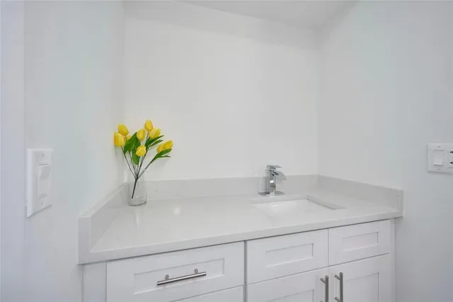 a bathroom with a sink a vanity and a mirror