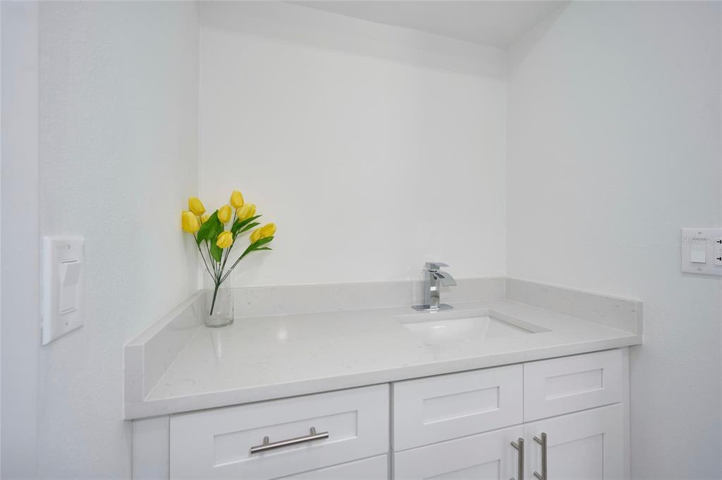 2310 Laguna Drive Indian Lake Estates, FL 33843 - Photo 19 of 27 a bathroom with a sink a vanity and a mirror