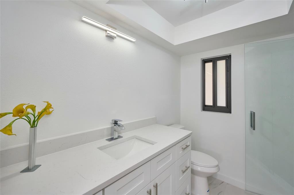 2310 Laguna Drive Indian Lake Estates, FL 33843 - Photo 23 of 27 a bathroom with a sink and a mirror