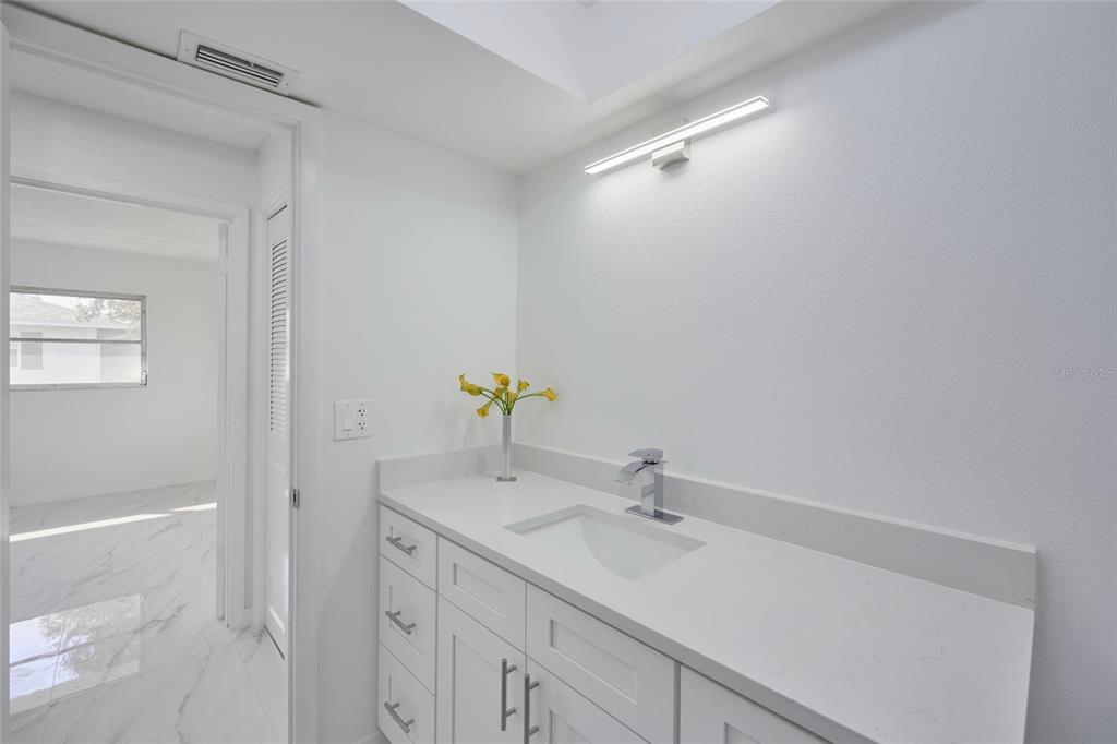 2310 Laguna Drive Indian Lake Estates, FL 33843 - Photo 24 of 27 a bathroom with a sink and a mirror