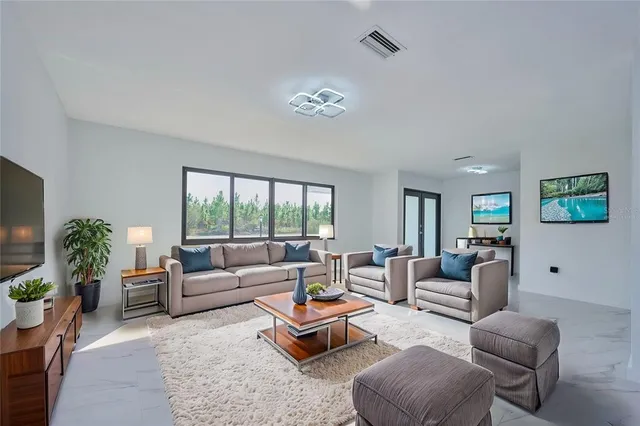 a living room with furniture and a large window