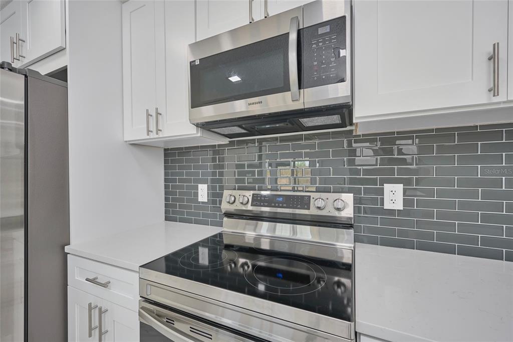2310 Laguna Drive Indian Lake Estates, FL 33843 - Photo 7 of 27 a kitchen with a stove and white cabinets