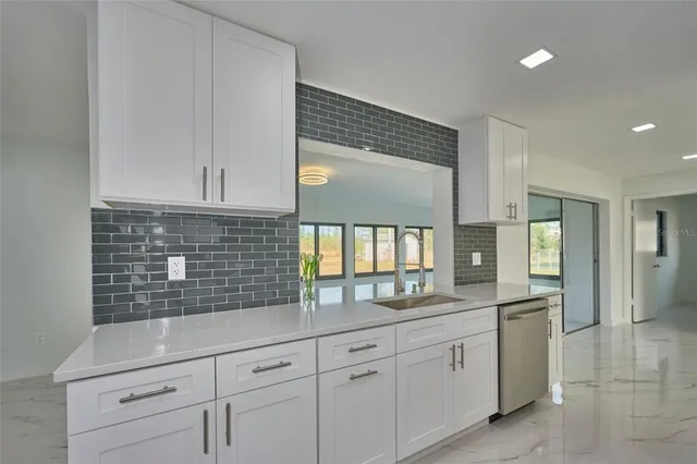 a kitchen with white cabinets