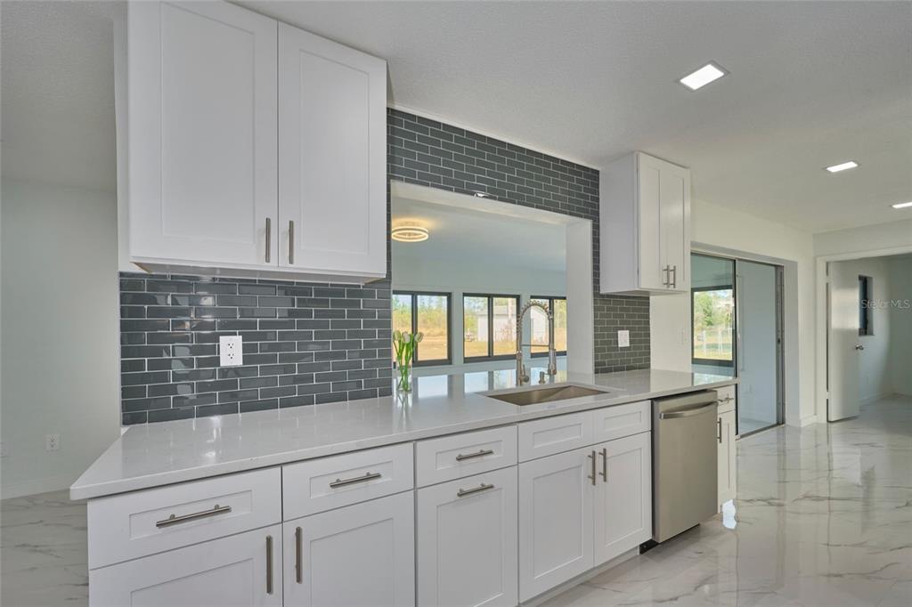 2310 Laguna Drive Indian Lake Estates, FL 33843 - Photo 8 of 27 a kitchen with white cabinets