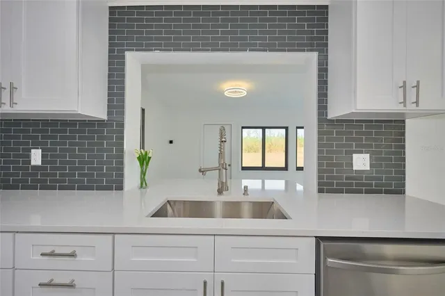 a kitchen with a sink and cabinets