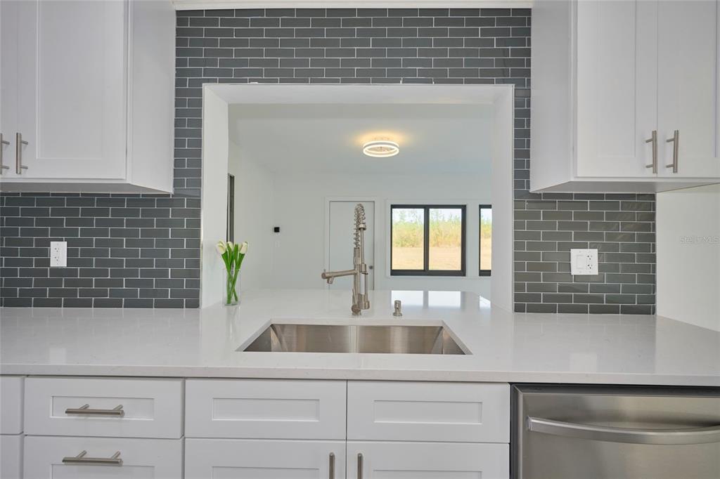 2310 Laguna Drive Indian Lake Estates, FL 33843 - Photo 9 of 27 a kitchen with a sink and cabinets