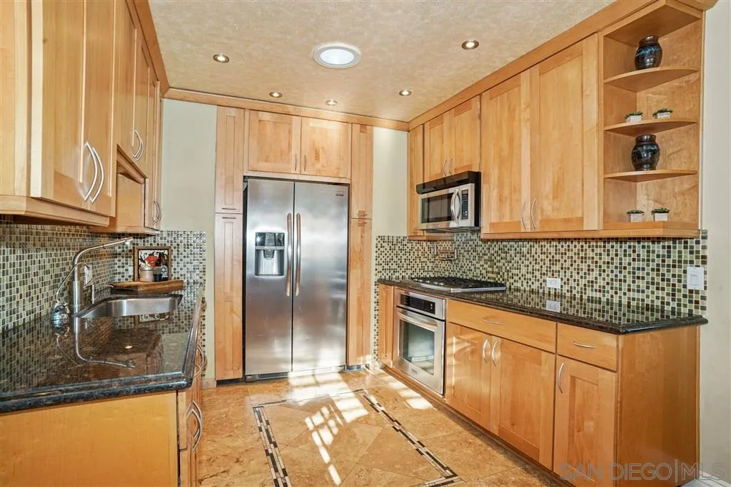 9808 Sierra Madre Road Spring Valley, CA 91977 - Photo 18 of 25 a kitchen with stainless steel appliances granite countertop a refrigerator and a stove