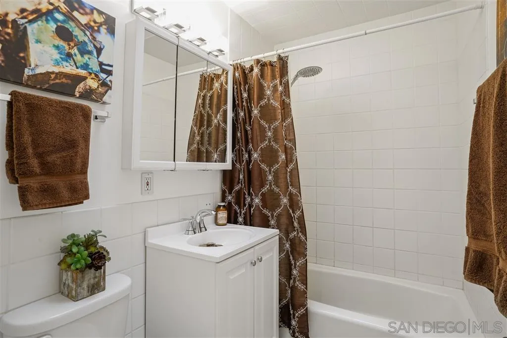 9808 Sierra Madre Road Spring Valley, CA 91977 - Photo 24 of 25 a bathroom with a shower curtain and a sink