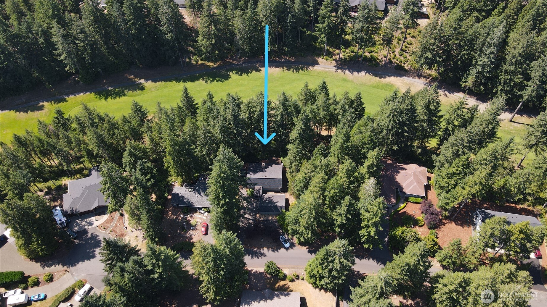 an aerial view of residential house with yard and outdoor seating