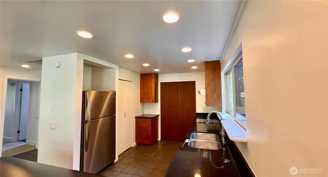 a kitchen with stainless steel appliances a refrigerator and a stove