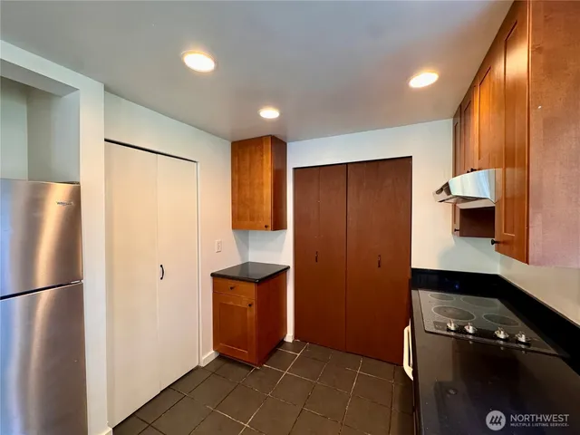 a kitchen with a refrigerator and cabinets