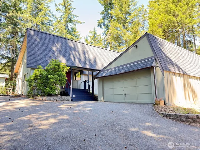 a view of a house with a garage and balcony