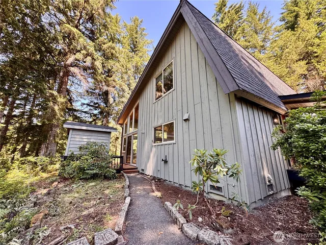 a backyard of a house with flower plants