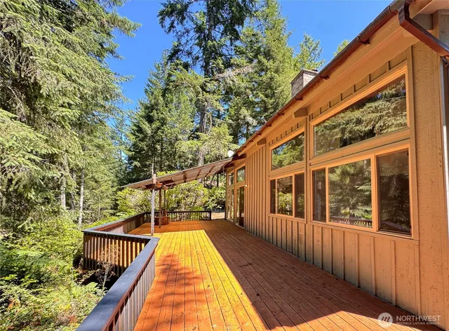 a view of balcony with wooden floor and fence and a potted plant