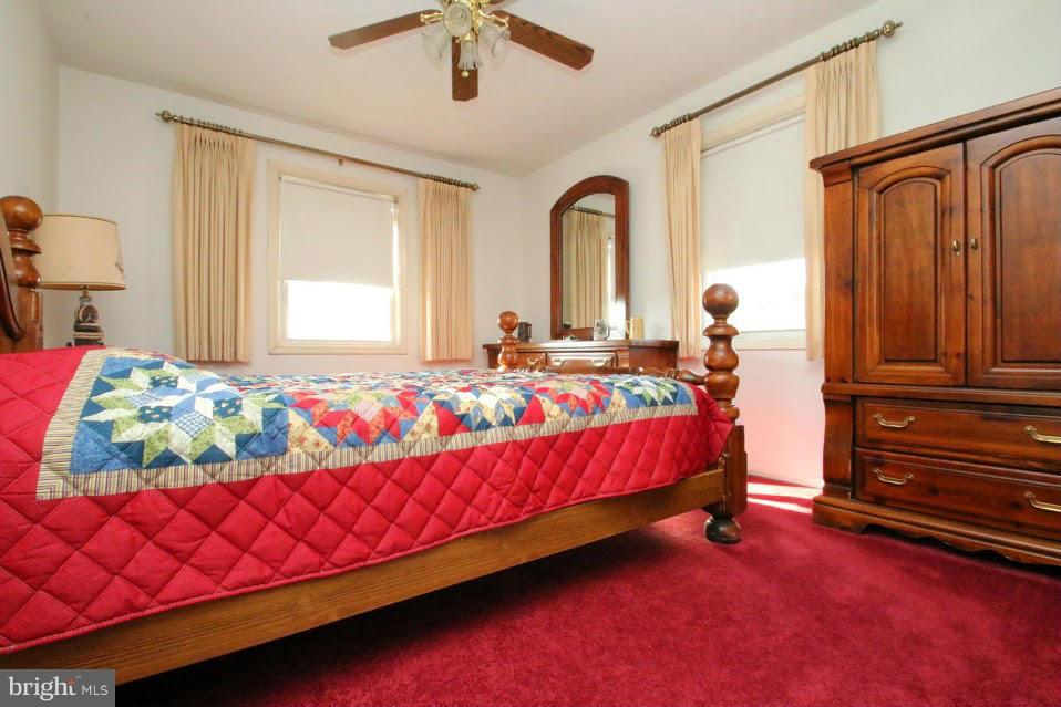 1711 Stokesley Road Baltimore, MD 21222 - Photo 16 of 30 a bedroom with a bed and wooden floor