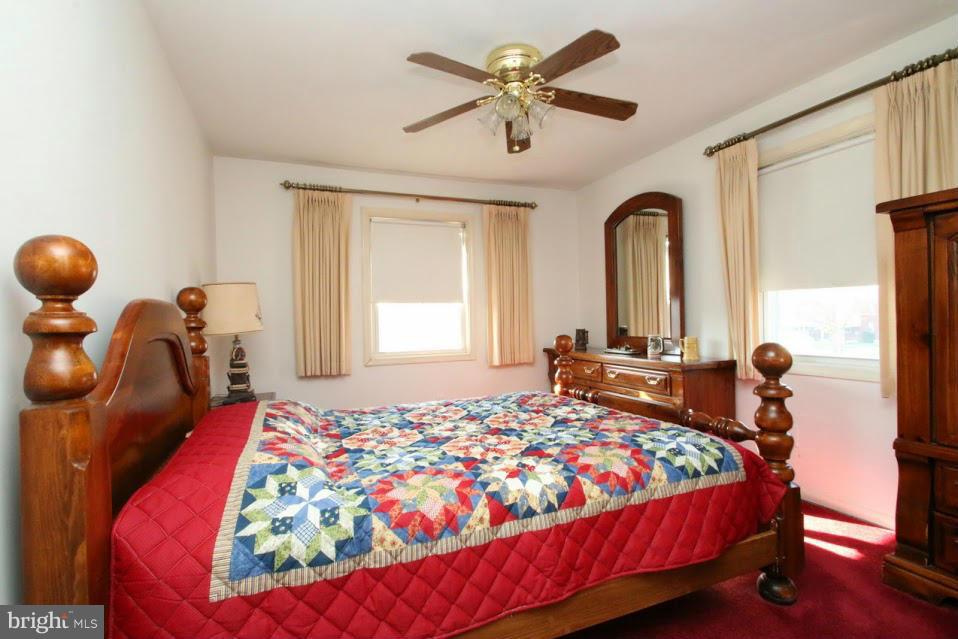 1711 Stokesley Road Baltimore, MD 21222 - Photo 18 of 30 a bedroom with a bed and a chandelier