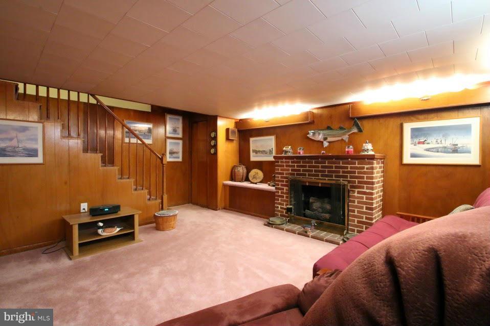 1711 Stokesley Road Baltimore, MD 21222 - Photo 20 of 30 a living room with furniture a fireplace and a flat screen tv
