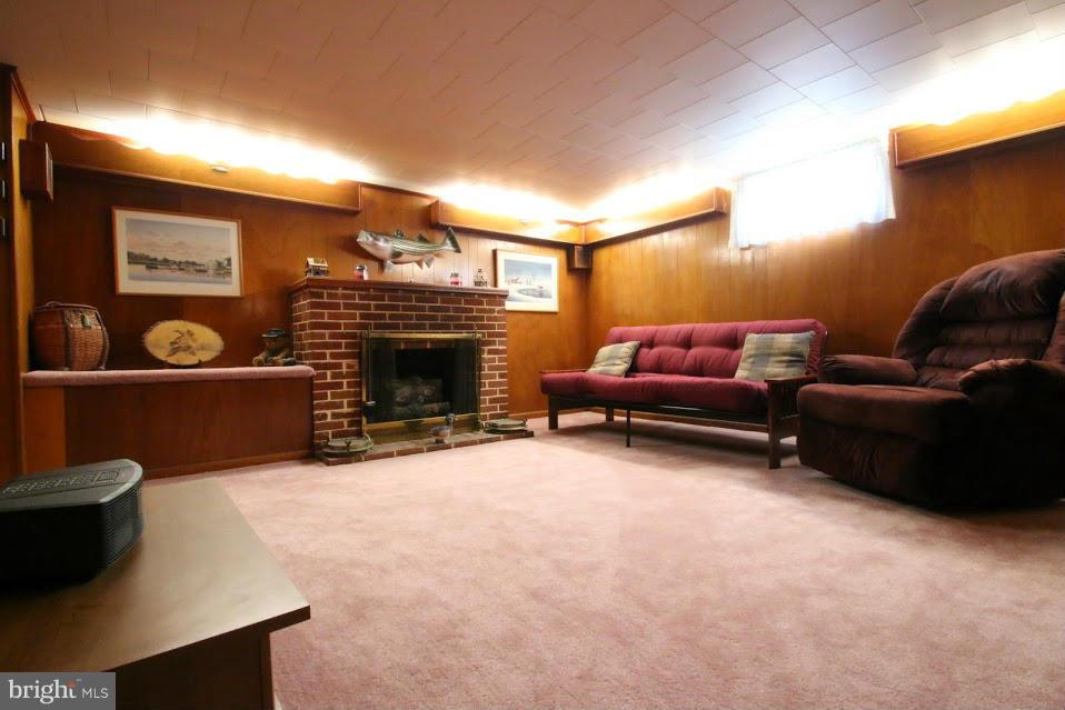 1711 Stokesley Road Baltimore, MD 21222 - Photo 21 of 30 a living room with furniture a fireplace and a flat screen tv