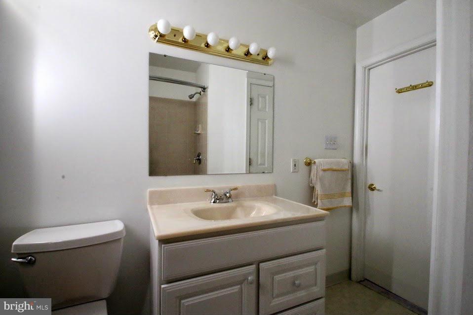 1711 Stokesley Road Baltimore, MD 21222 - Photo 22 of 30 a bathroom with a sink vanity and a mirror