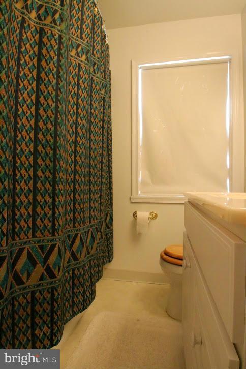 1711 Stokesley Road Baltimore, MD 21222 - Photo 23 of 30 a bathroom with a granite countertop sink a toilet and shower