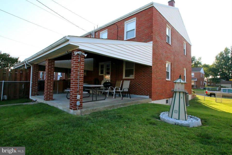 1711 Stokesley Road Baltimore, MD 21222 - Photo 28 of 30 a front view of a house with garden and a bench