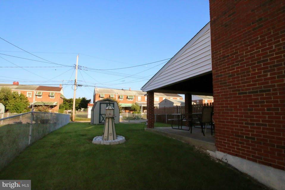 1711 Stokesley Road Baltimore, MD 21222 - Photo 29 of 30 a view of a patio with a table chairs and a backyard