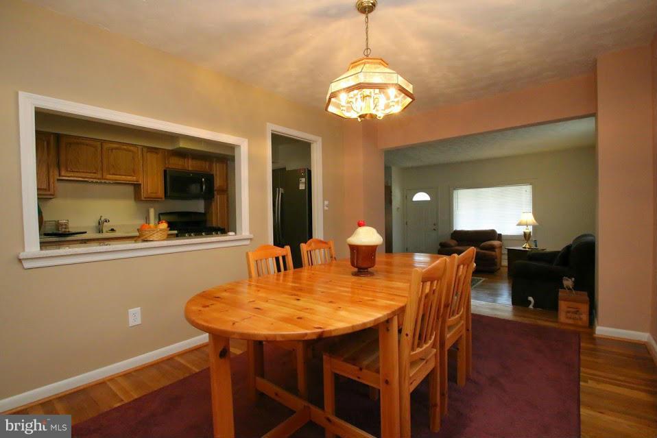 1711 Stokesley Road Baltimore, MD 21222 - Photo 6 of 30 a view of a dining room with furniture and wooden floor
