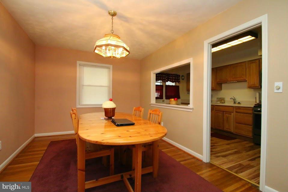 1711 Stokesley Road Baltimore, MD 21222 - Photo 7 of 30 a view of a dining room with furniture window and wooden floor