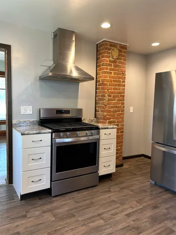 a kitchen with stainless steel appliances a stove and a refrigerator
