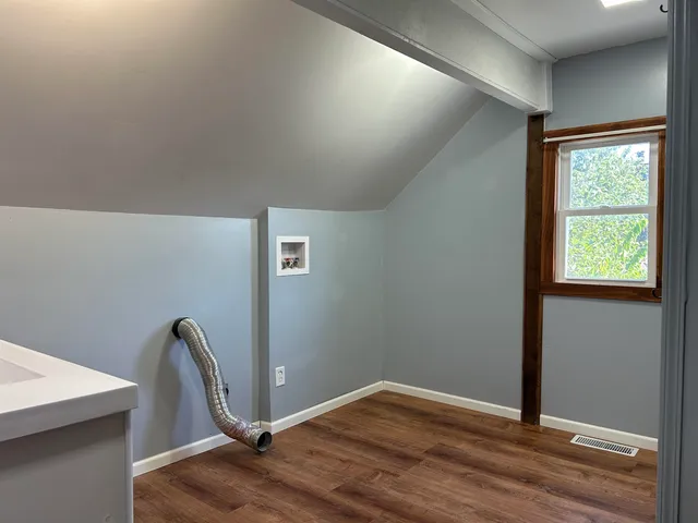 a spacious bathroom with a toilet sink and mirror
