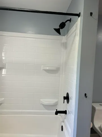 a view of a hallway with wooden floor and cabinet
