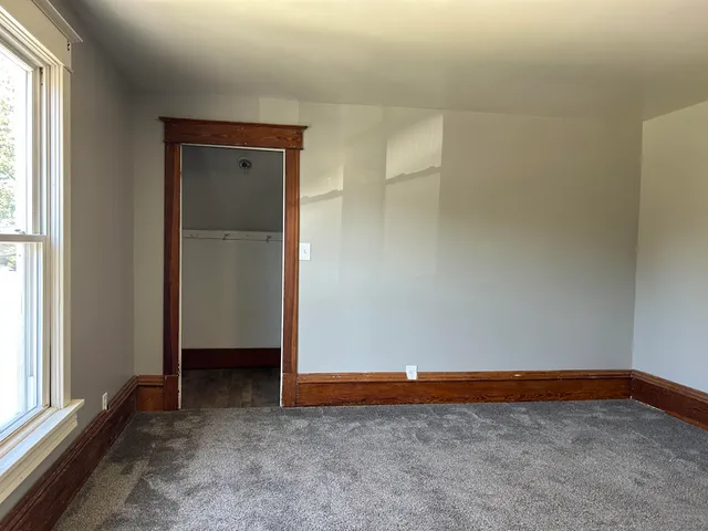an empty room with closet area