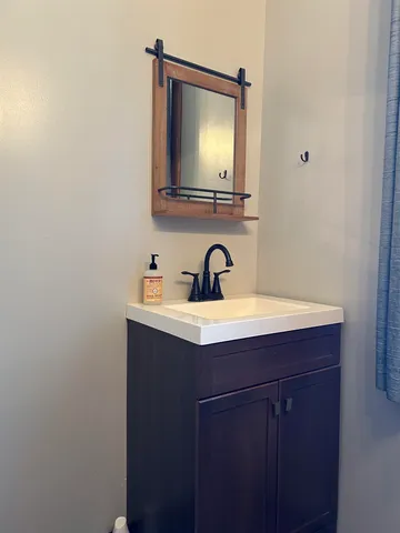 a bathroom with a sink and a mirror