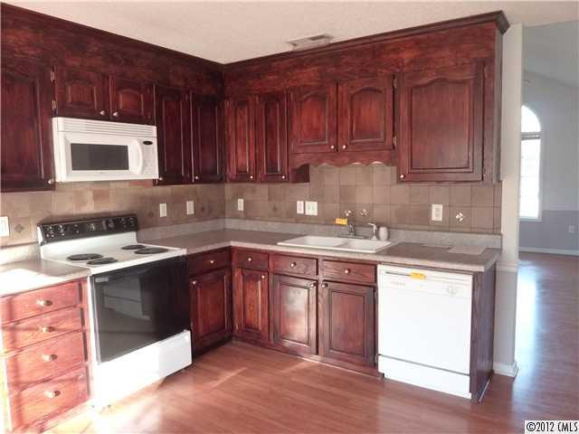 1105 Crescent Way Wingate, NC 28174 - Photo 2 of 11 a kitchen with stainless steel appliances granite countertop a sink stove and cabinets