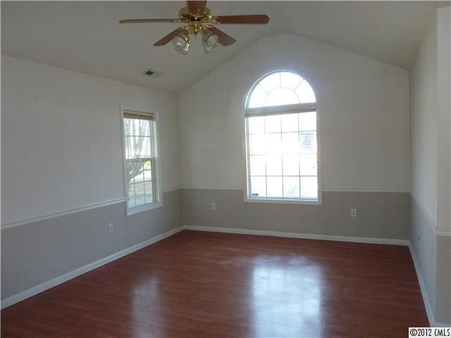 1105 Crescent Way Wingate, NC 28174 - Photo 3 of 11 a view of an empty room with wooden floor and window