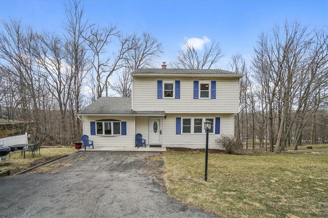 a view of house with a yard