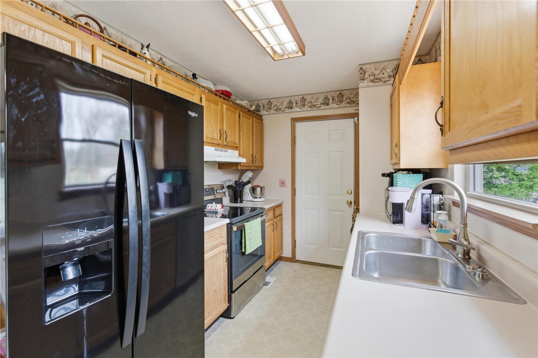 8747 Waynes Way Blanchester, OH 45107 - Photo 8 of 40 This kitchen features classic wooden cabinetry and essential appliances for comfortable living.