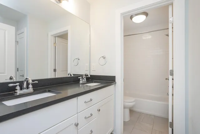 an empty room with wooden floor and a window