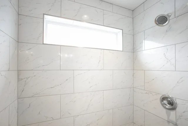 a large kitchen with stainless steel appliances granite countertop a refrigerator and a stove top oven