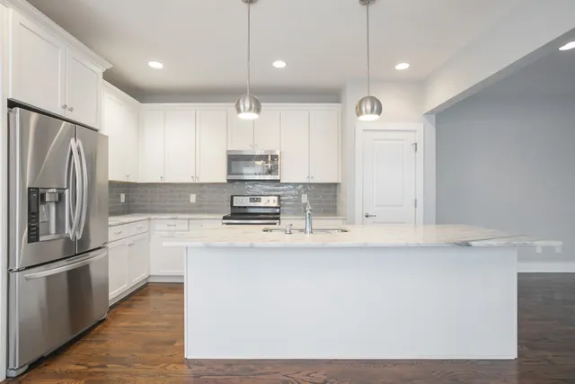 a view of a kitchen with a sink and a window