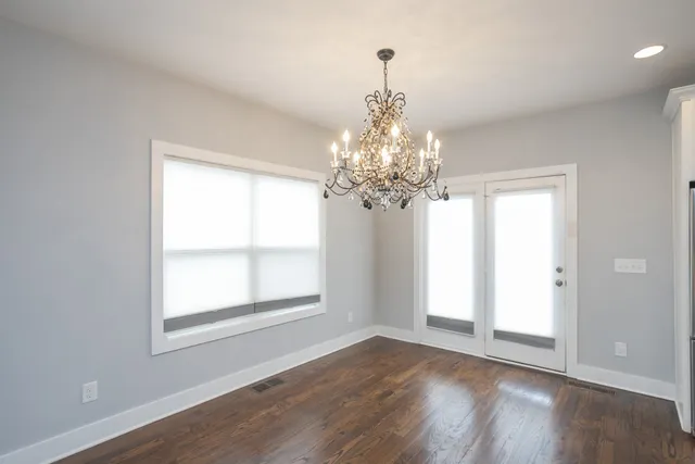 a large kitchen with stainless steel appliances granite countertop a refrigerator and a stove top oven