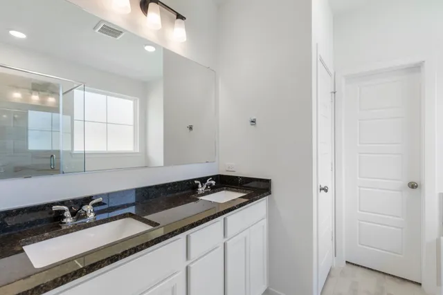a bathroom with a glass shower door