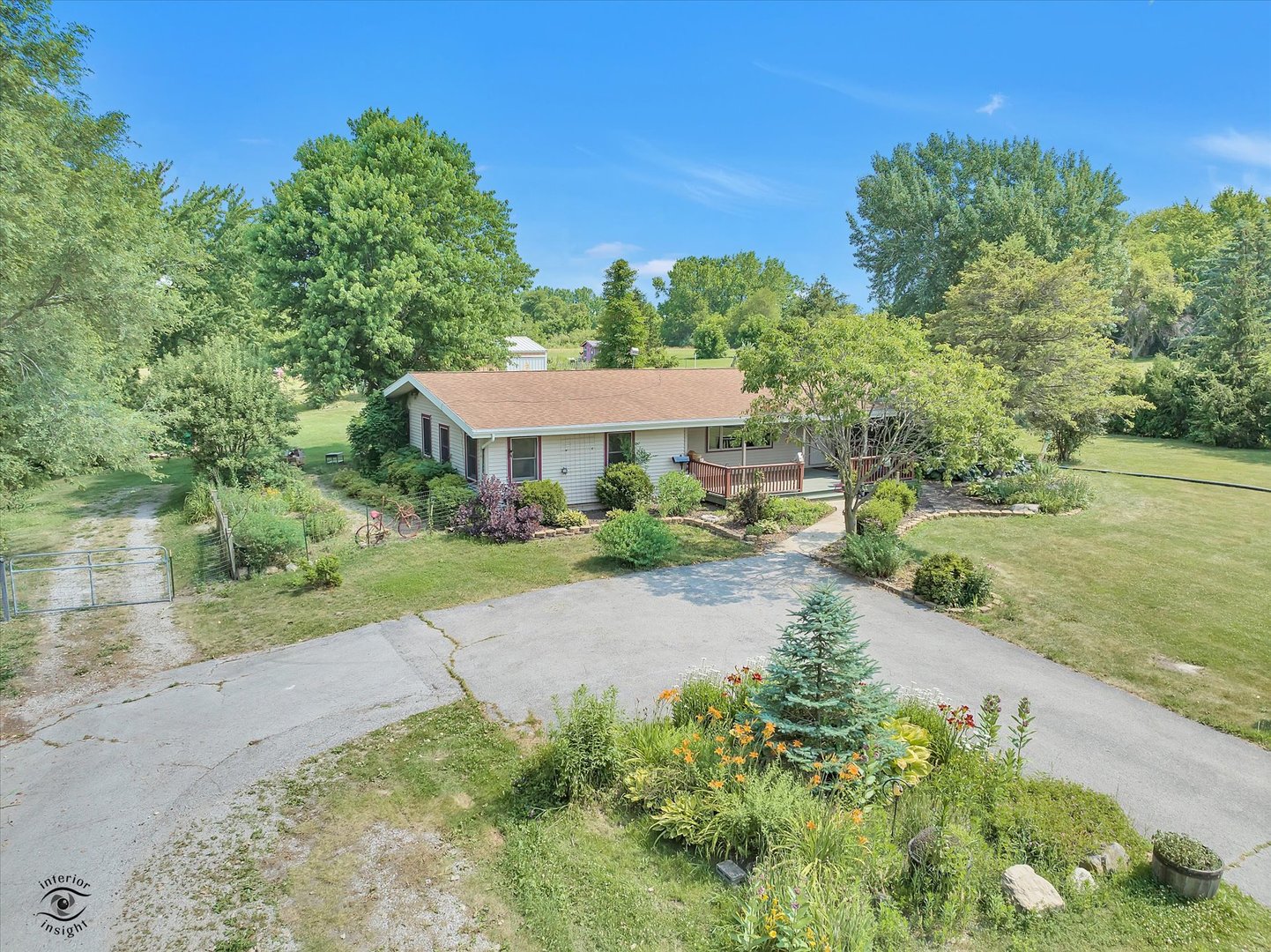 an outdoor view of a house with garden and patio